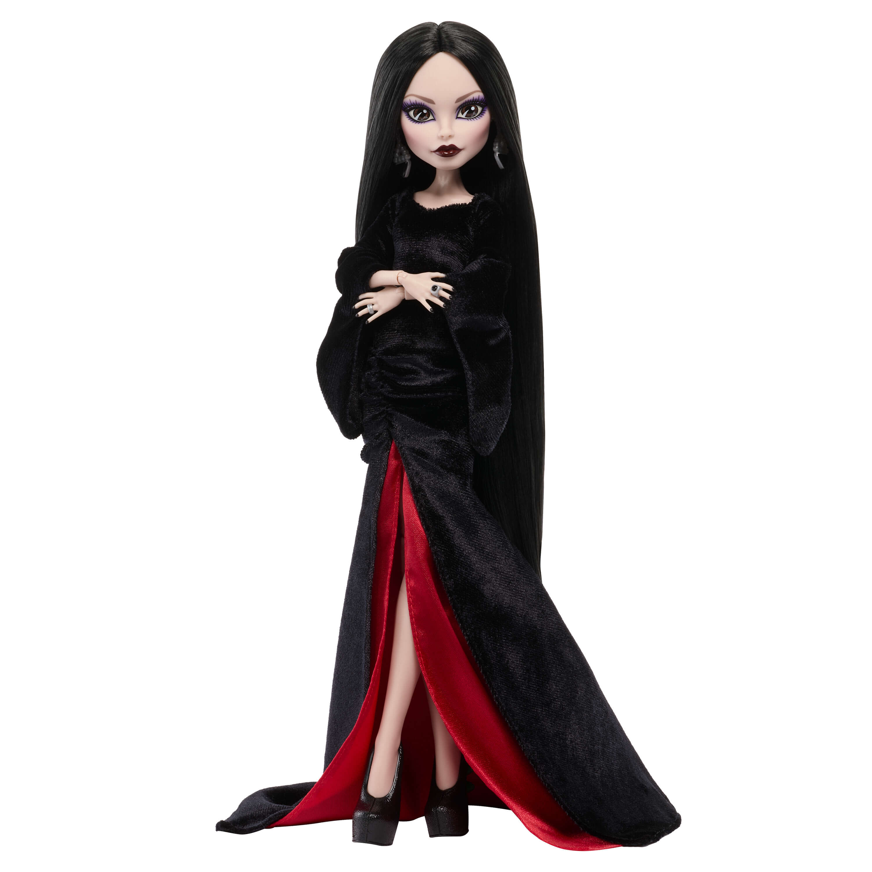 Muñeca gótica con largo pelo negro, vestido de terciopelo negro con forro rojo y tacones altos sobre fondo blanco.