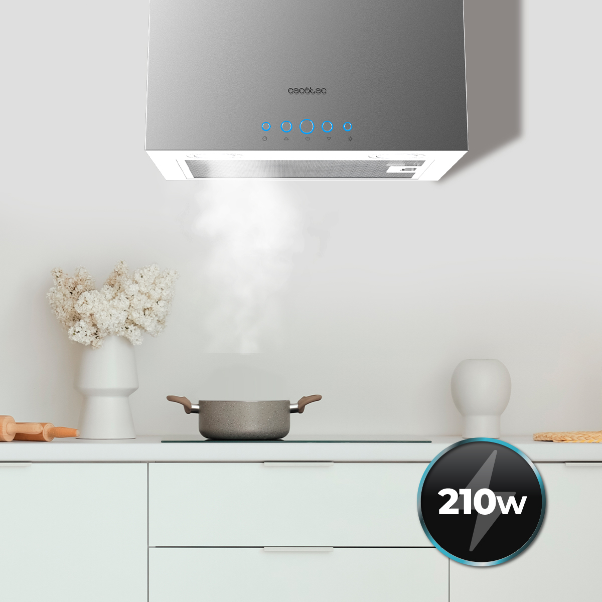 Una campana extractora de acero inoxidable sobre una encimera con una olla humeante en una cocina.