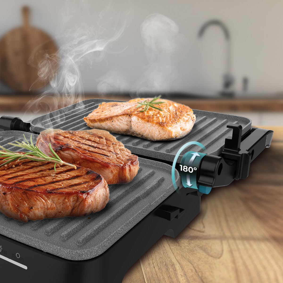 Steak und Fisch braten auf einem elektrischen Tischgrill in einer Küche mit aufsteigendem Dampf.