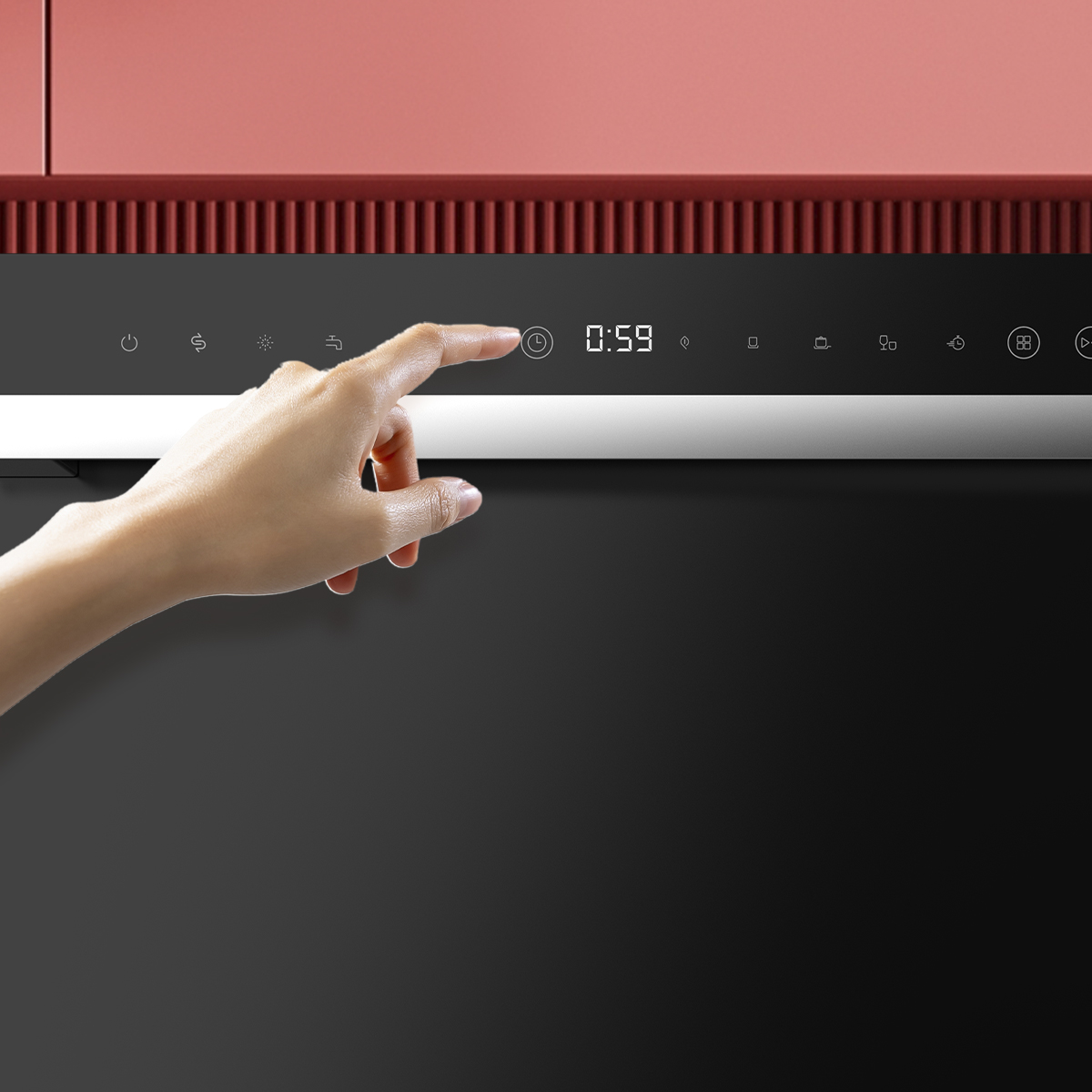 Una mano toca el panel de control digital de un electrodoméstico negro bajo armarios rojos.