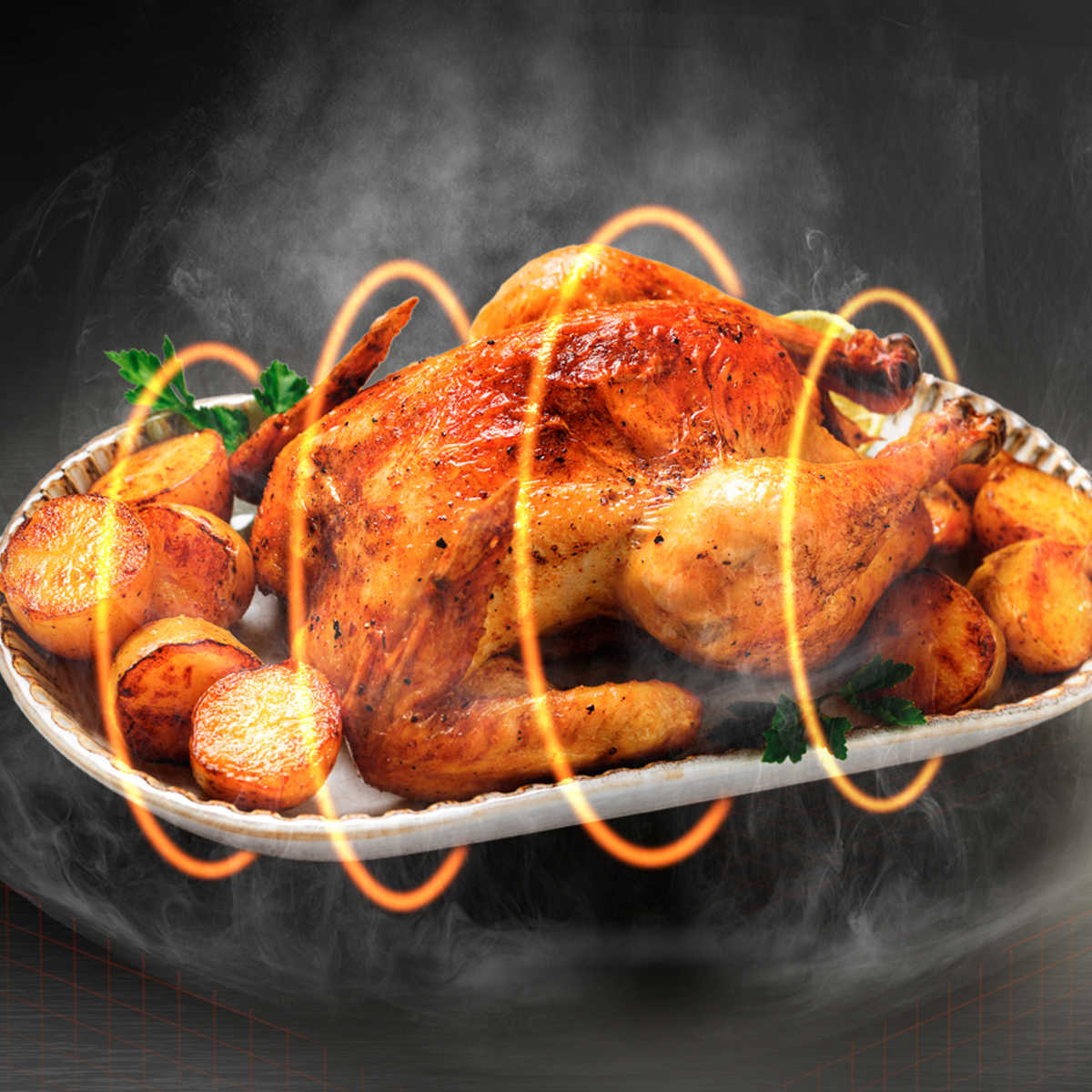 Pollo asado con patatas en un plato, rodeado de vapor y anillos naranjas.