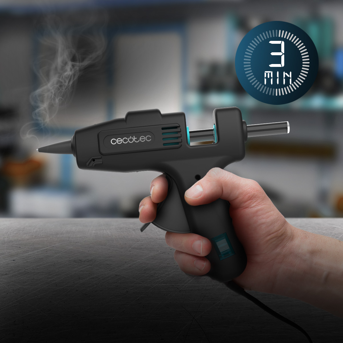 Una mano sostiene una pistola de pegamento caliente negra con vapor y un indicador de tres minutos.