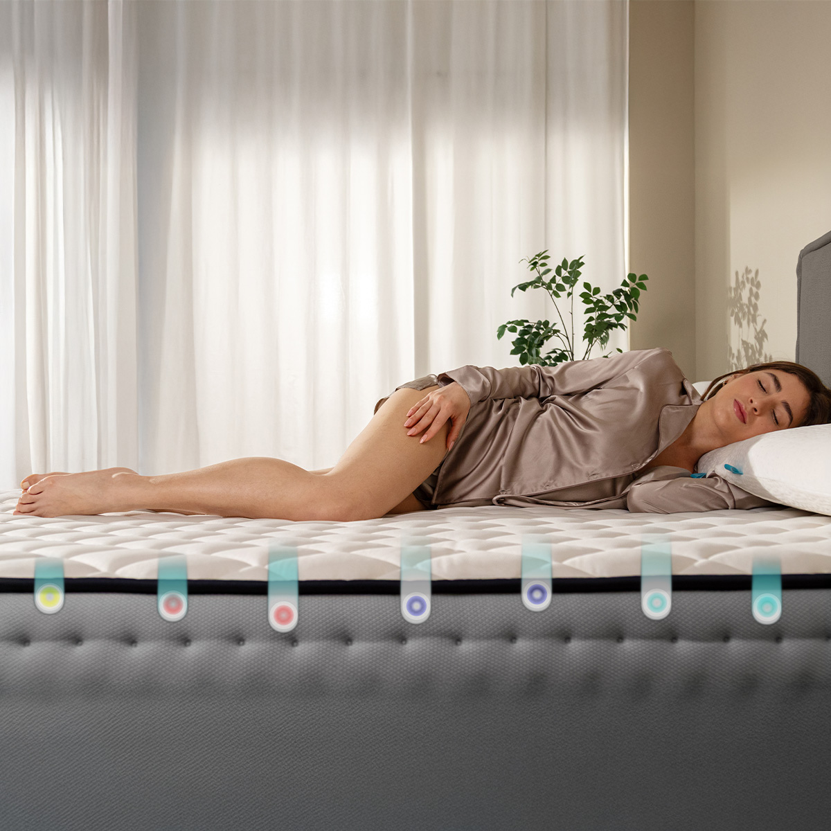 Una mujer duerme plácidamente en un colchón firme con luces indicadoras coloridas a un lado.