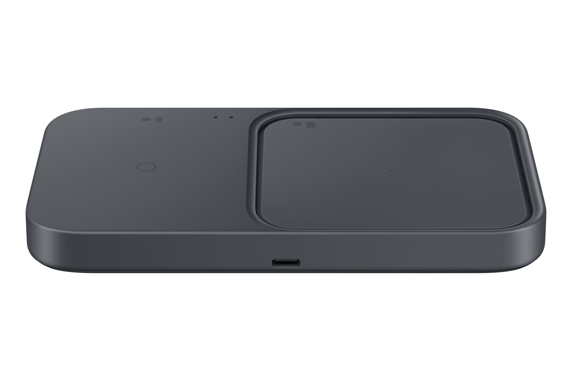 Szara, płaska podwójna ładowarka bezprzewodowa z zaokrąglonymi rogami i portem USB-C z przodu, na czarnym tle.