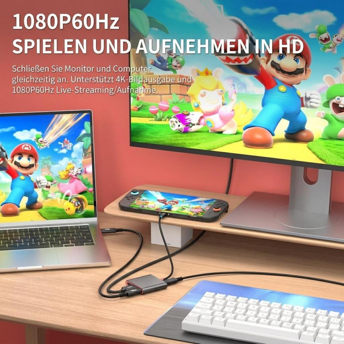 Gaming-Setup mit Laptop, Monitor, Switch und Capture Card auf Holztisch.