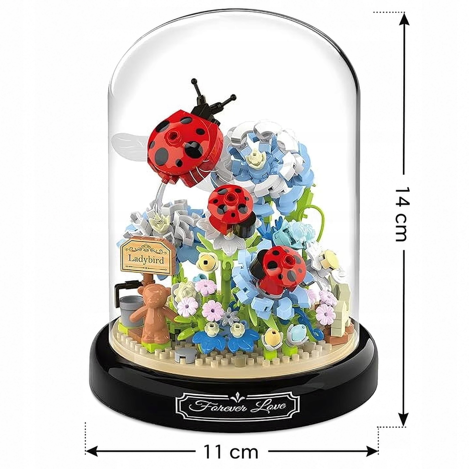 Model Lego z biedronkami, kwiatami i misiem pod szklaną kopułą o wysokości 14 cm.