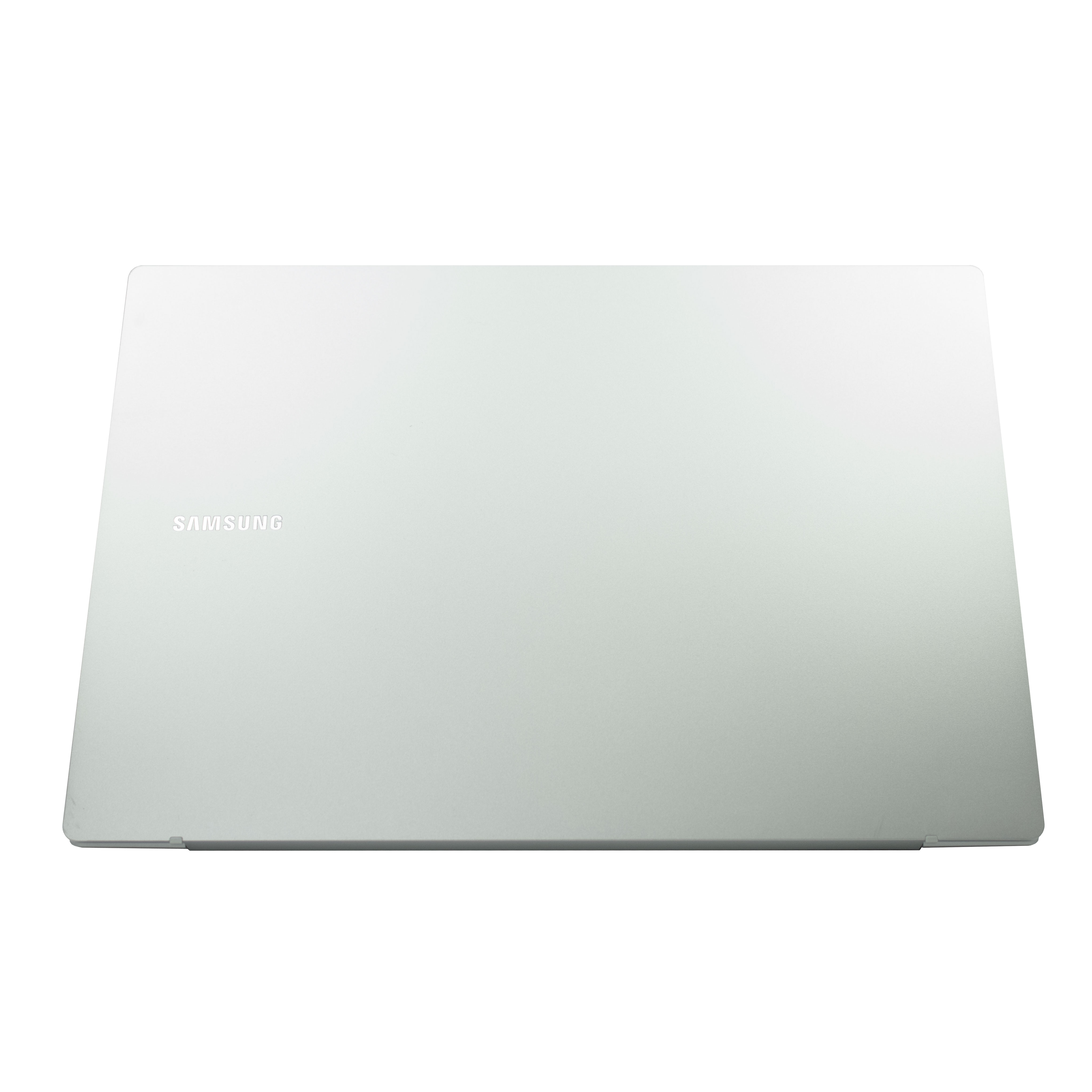 Zamknięty srebrny laptop Samsung na białym tle.