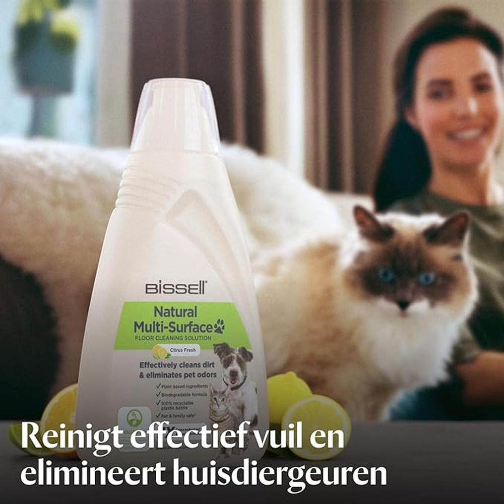 Bissell Bodenreiniger Flasche mit Zitrone, Katze und Frau im Hintergrund.