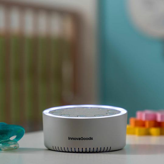 Un dispositivo blanco InnovaGoods con borde luminoso sobre una mesa en una habitación infantil.
