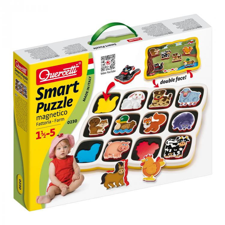 Una caja de Quercetti Smart Puzzle con piezas magnéticas de animales de granja y un bebé sentado.