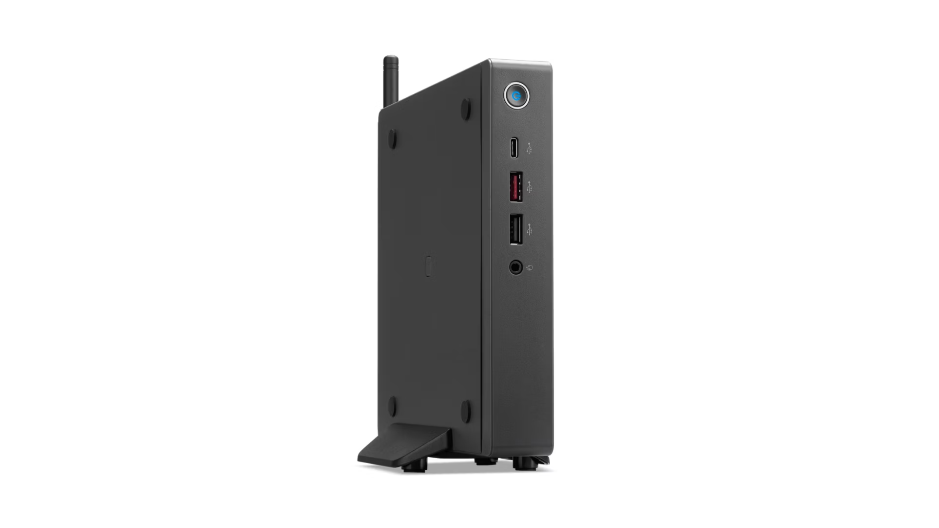 Un mini PC nero è posizionato verticalmente su un supporto con sfondo bianco e porte USB.