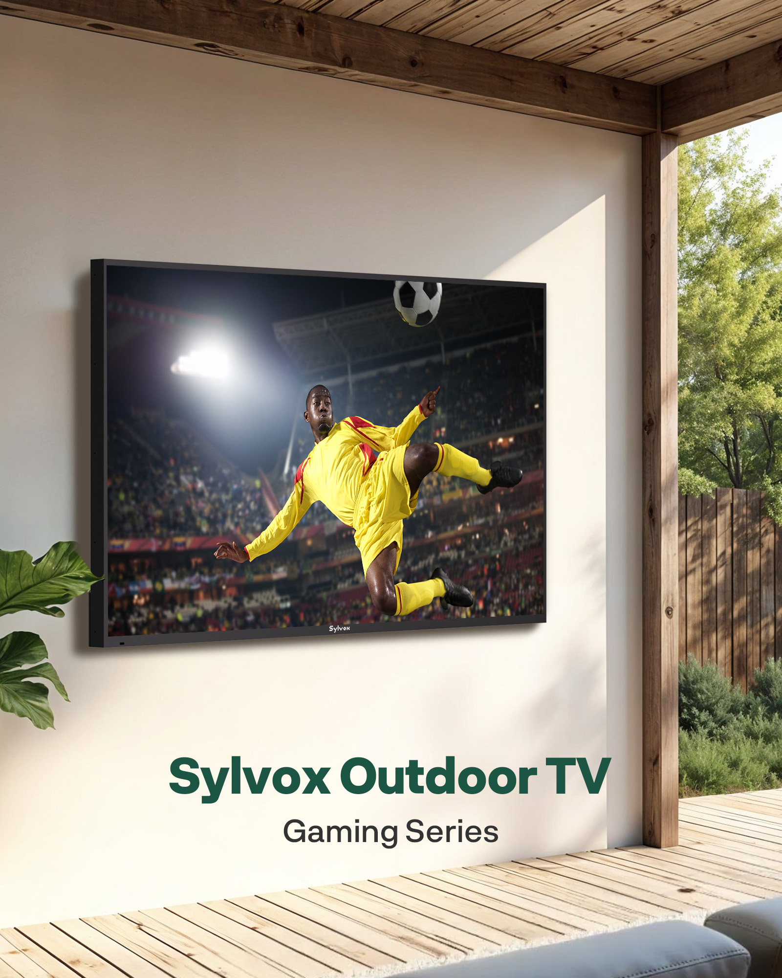 Un televisor de exterior Sylvox en una pared muestra a un futbolista en acción. Al fondo se ven un patio y árboles.