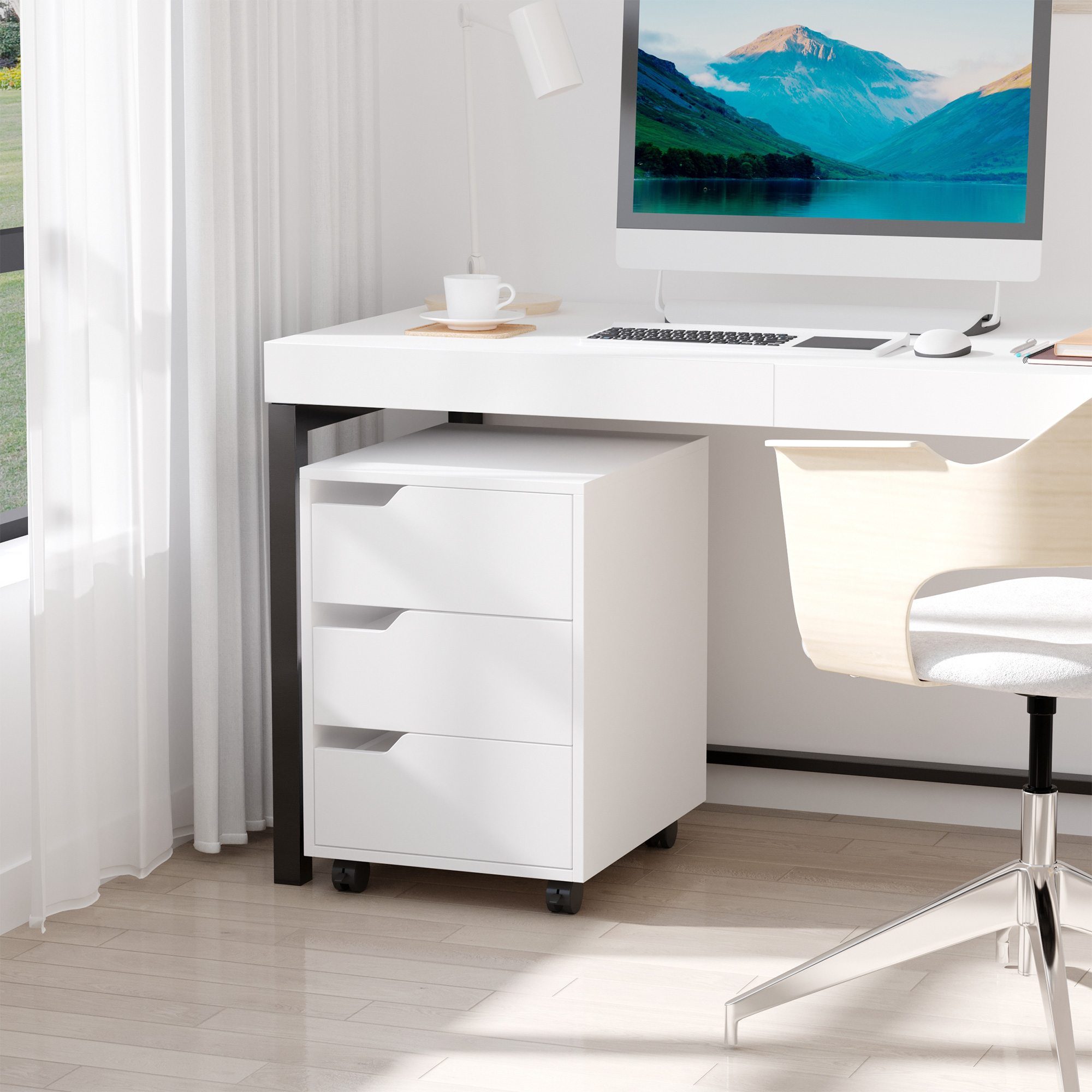 Un escritorio blanco con una computadora y un archivador con tres cajones debajo, junto a una ventana con cortinas.