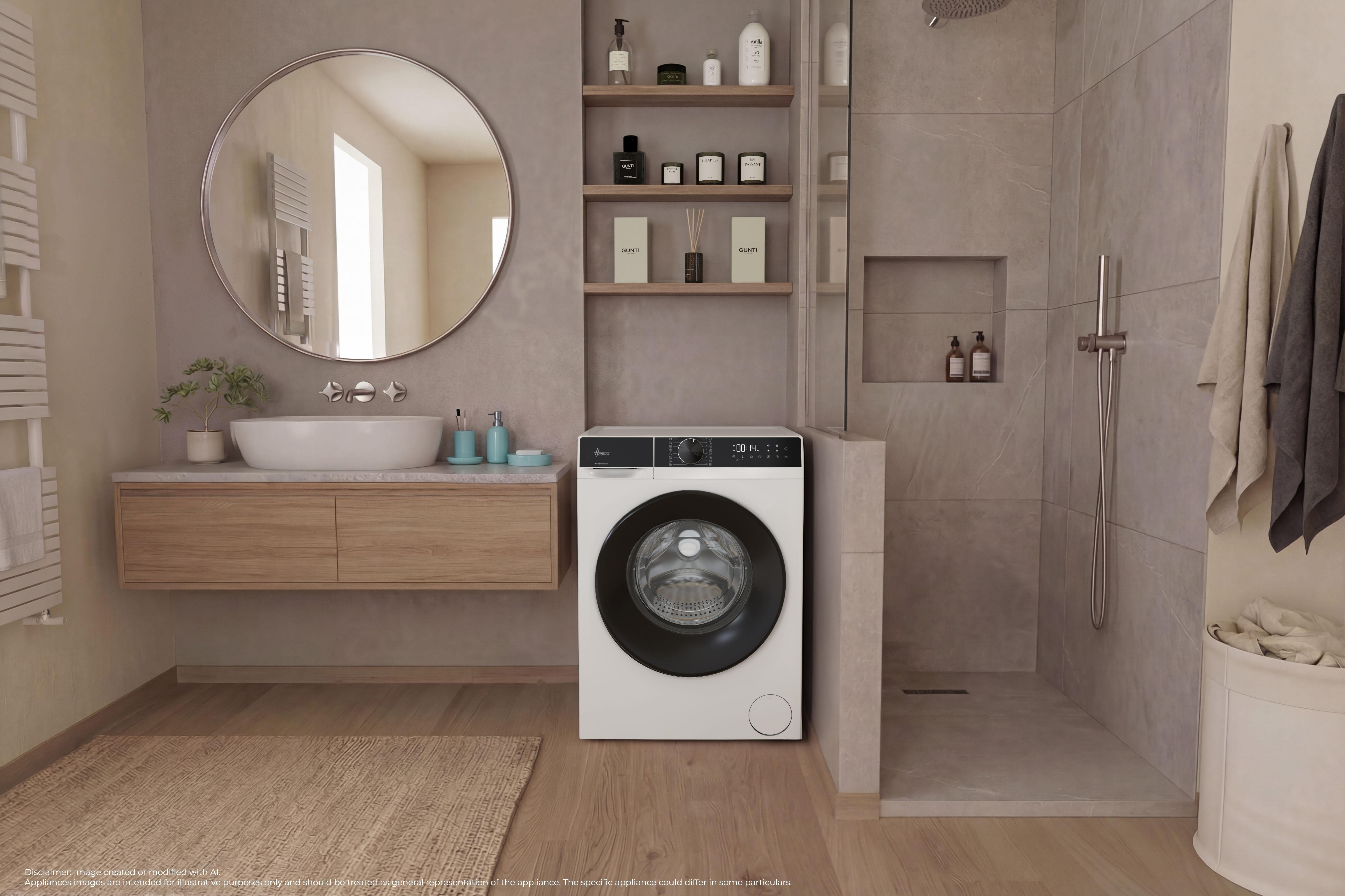 Çamaşır makinesi, ahşap dolap, büyük yuvarlak ayna ve gri fayanslı duşa sahip modern banyo.