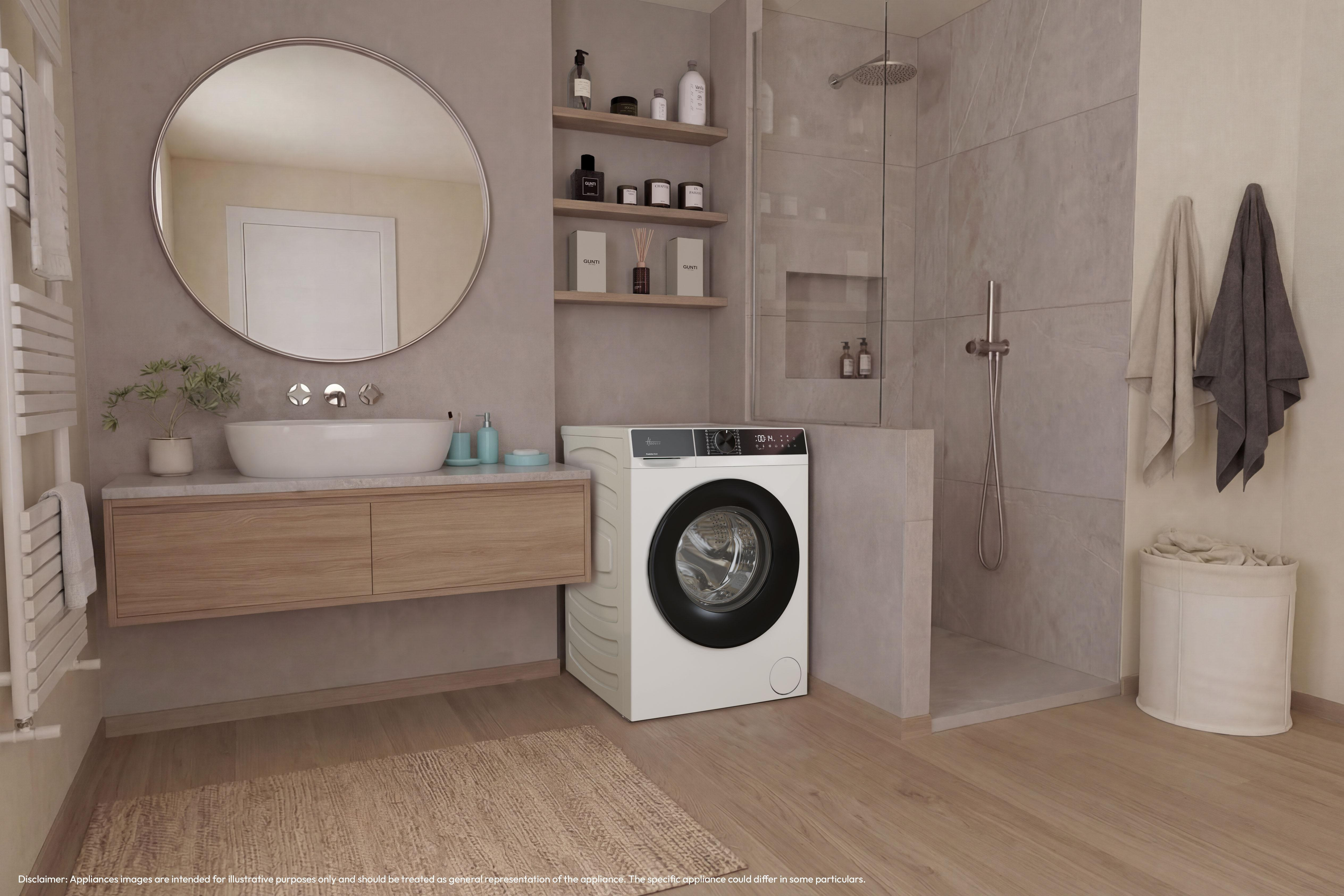 Çamaşır makineli, ahşap dolaplı, yuvarlak aynalı ve gri fayanslı duşakabinli modern banyo.