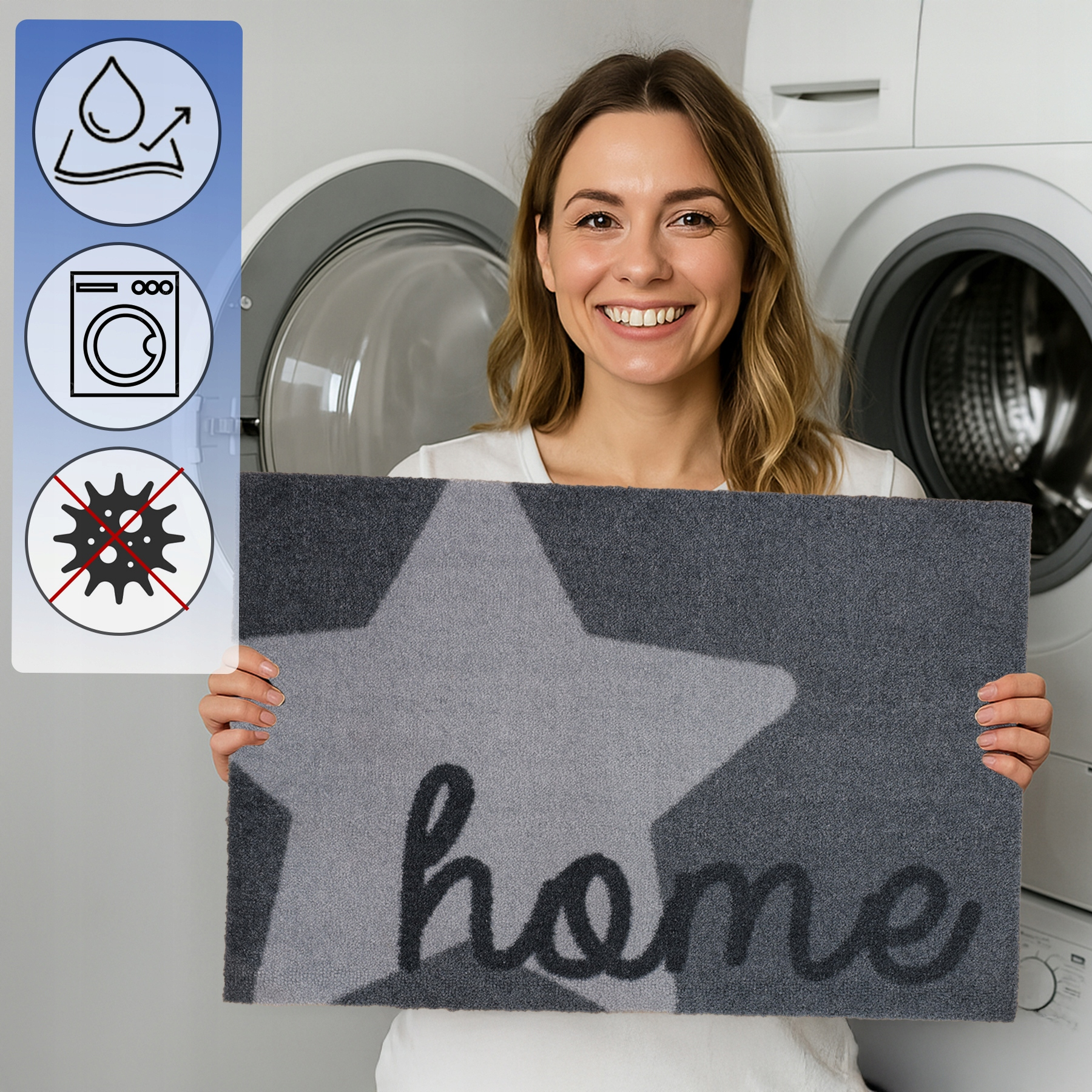 Uśmiechnięta kobieta trzyma szarą wycieraczkę z gwiazdą i napisem 'home' w pralni.