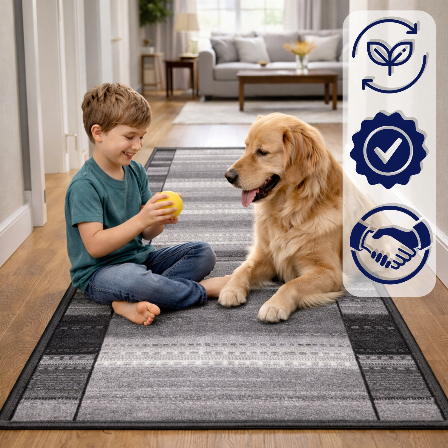 Chłopiec siedzi na szaro-białym dywanie, trzymając żółtą piłkę obok psa rasy golden retriever.