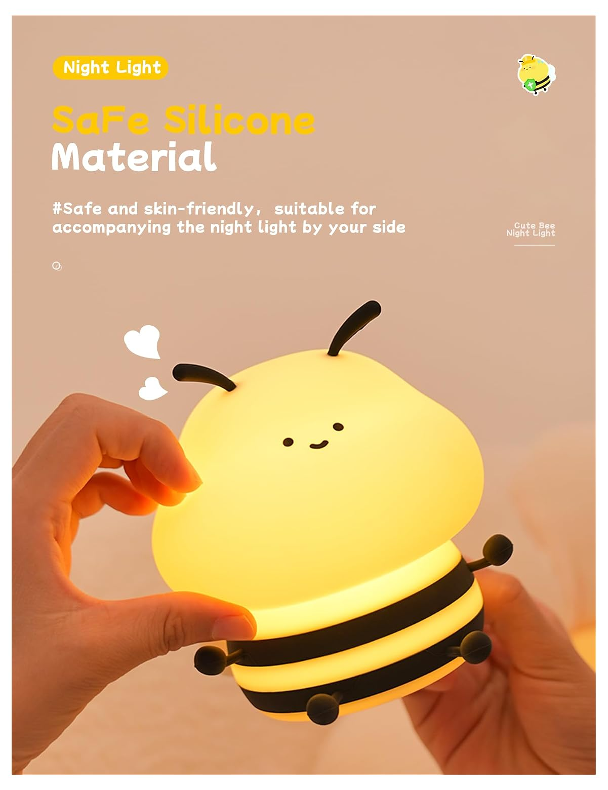 Eine Hand drückt eine weiche, gelbe Bienen-Nachtlampe mit schwarzen Streifen und einem niedlichen Gesicht.