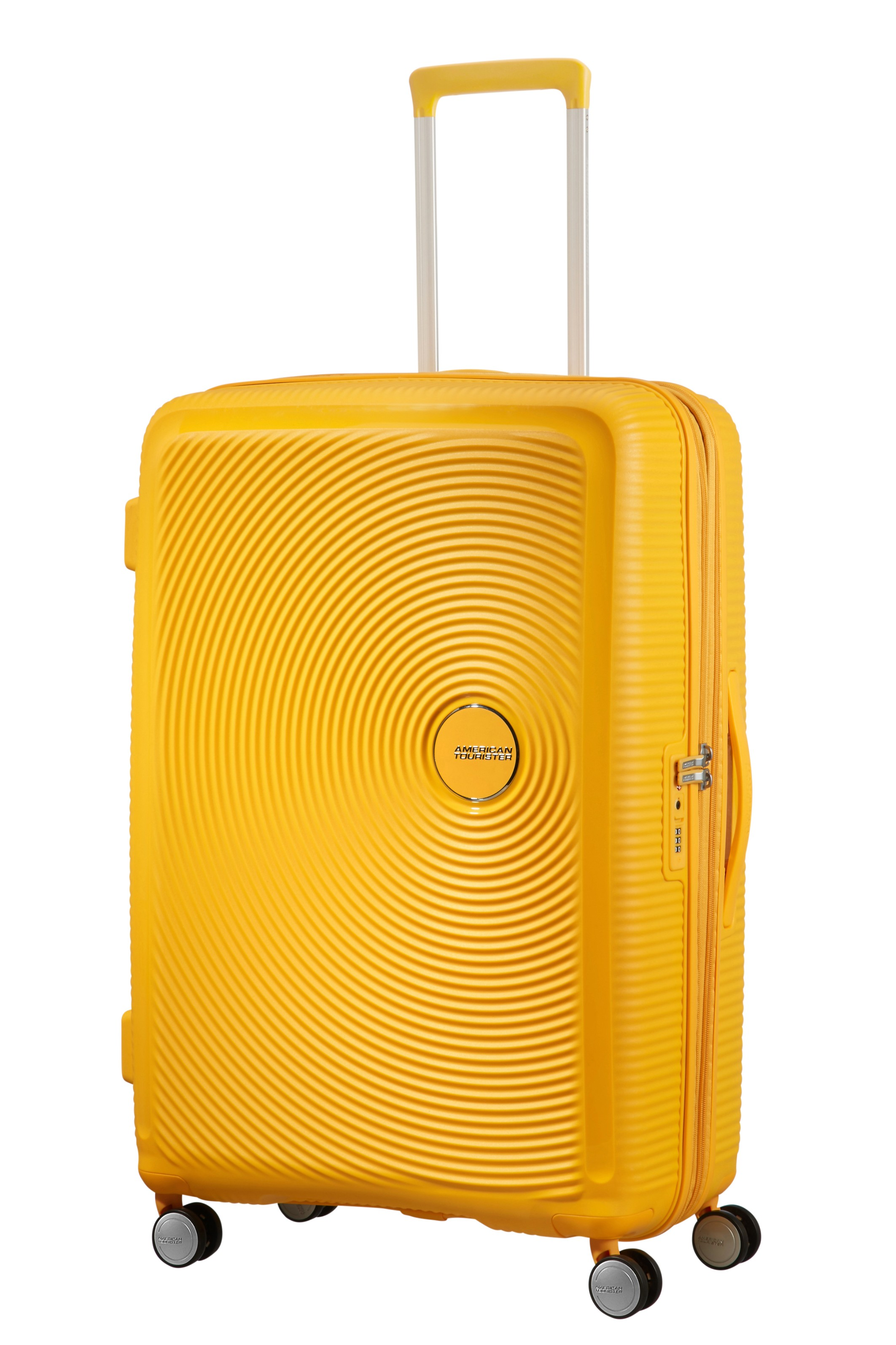 Jasnożółta walizka American Tourister z okrągłym wzorem i wysuwaną rączką na białym tle.