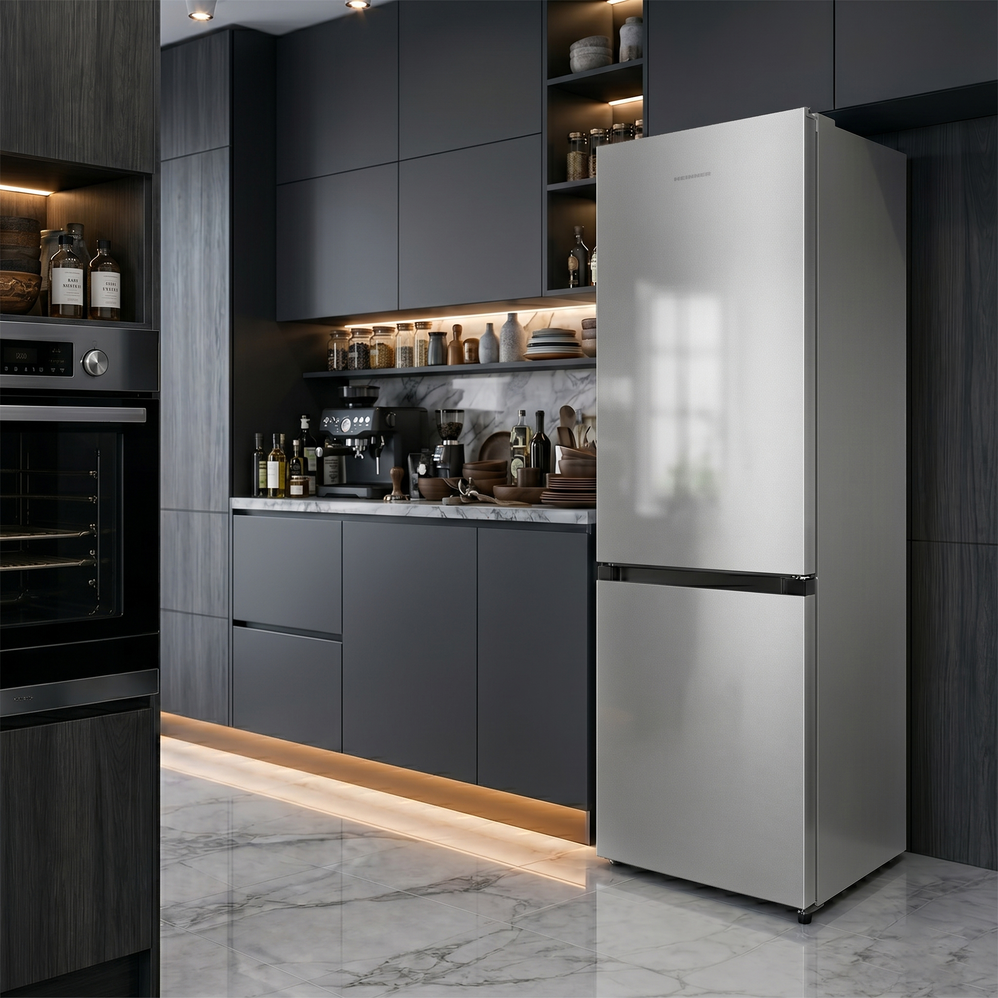Modern gray kitchen with a silver refrigerator, marble countertop, and integrated appliances.