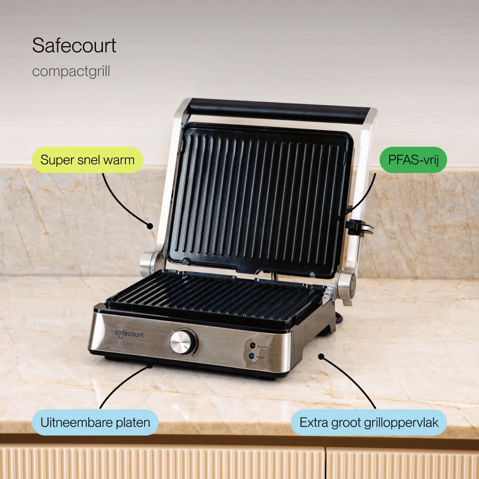 An open Safecourt compact grill sits on a marble countertop with text boxes pointing out its features.