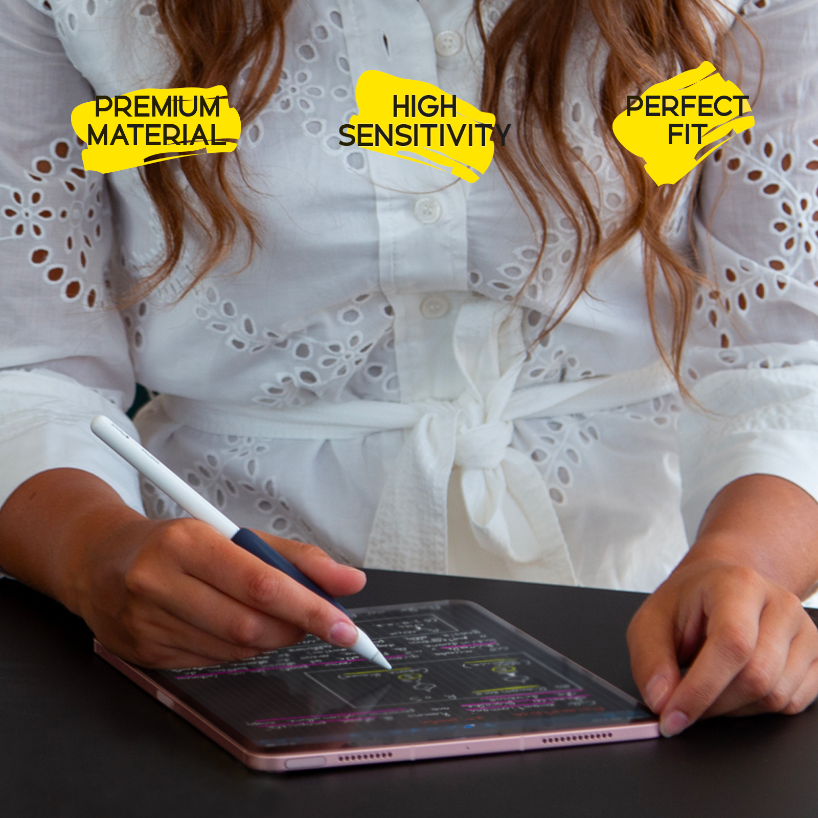 Una donna con una camicetta bianca scrive su un tablet con uno stilo.
