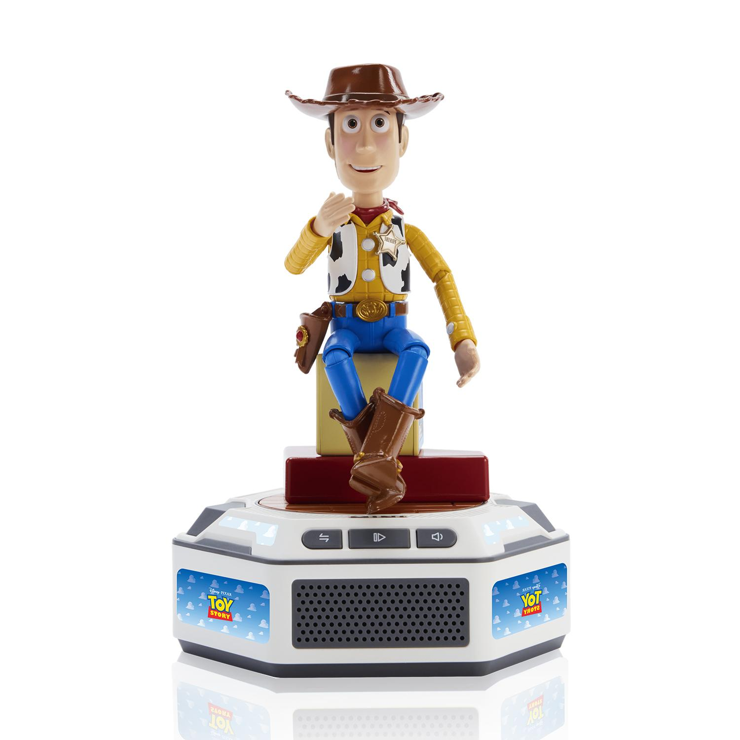 Una figura de acción de Woody de Toy Story sentado en una base de altavoz interactiva blanca y gris.