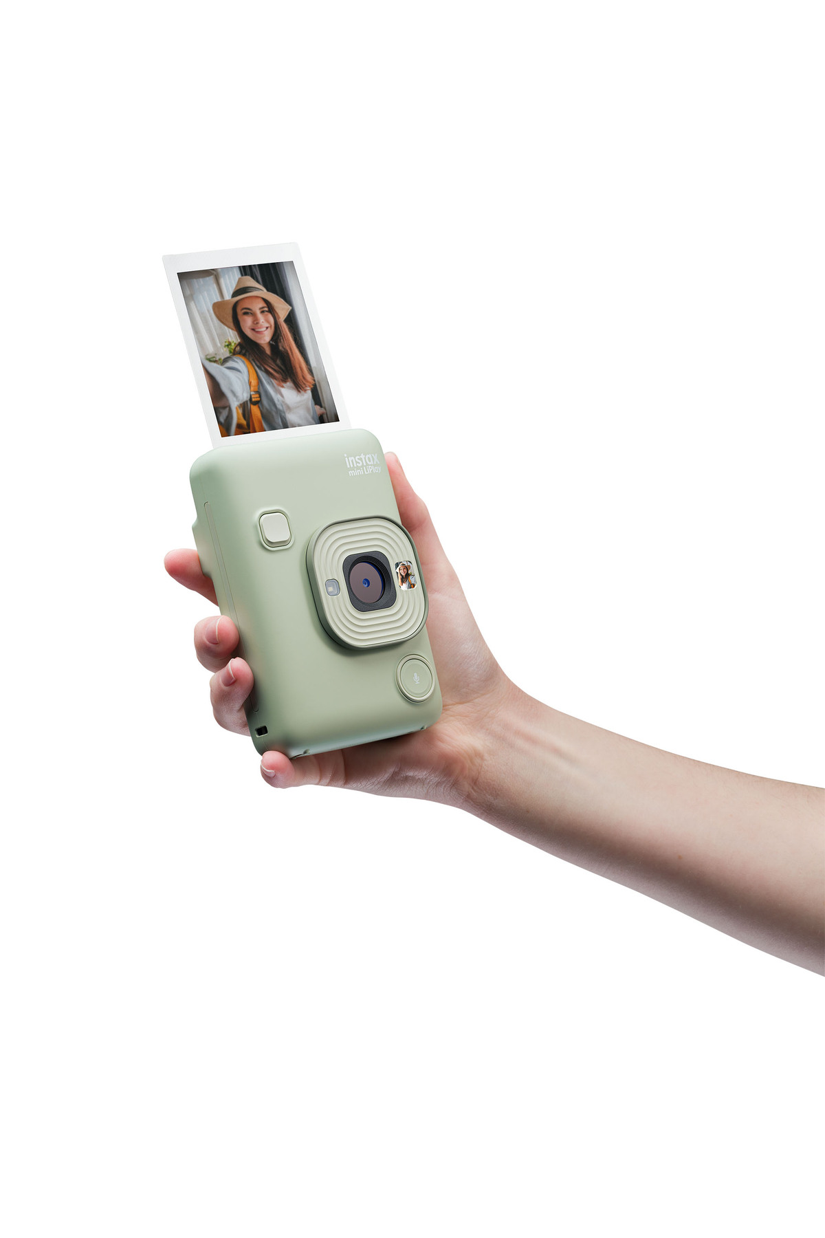Bir el, bir kadının basılı fotoğrafını içeren açık yeşil bir anlık kamera tutuyor.