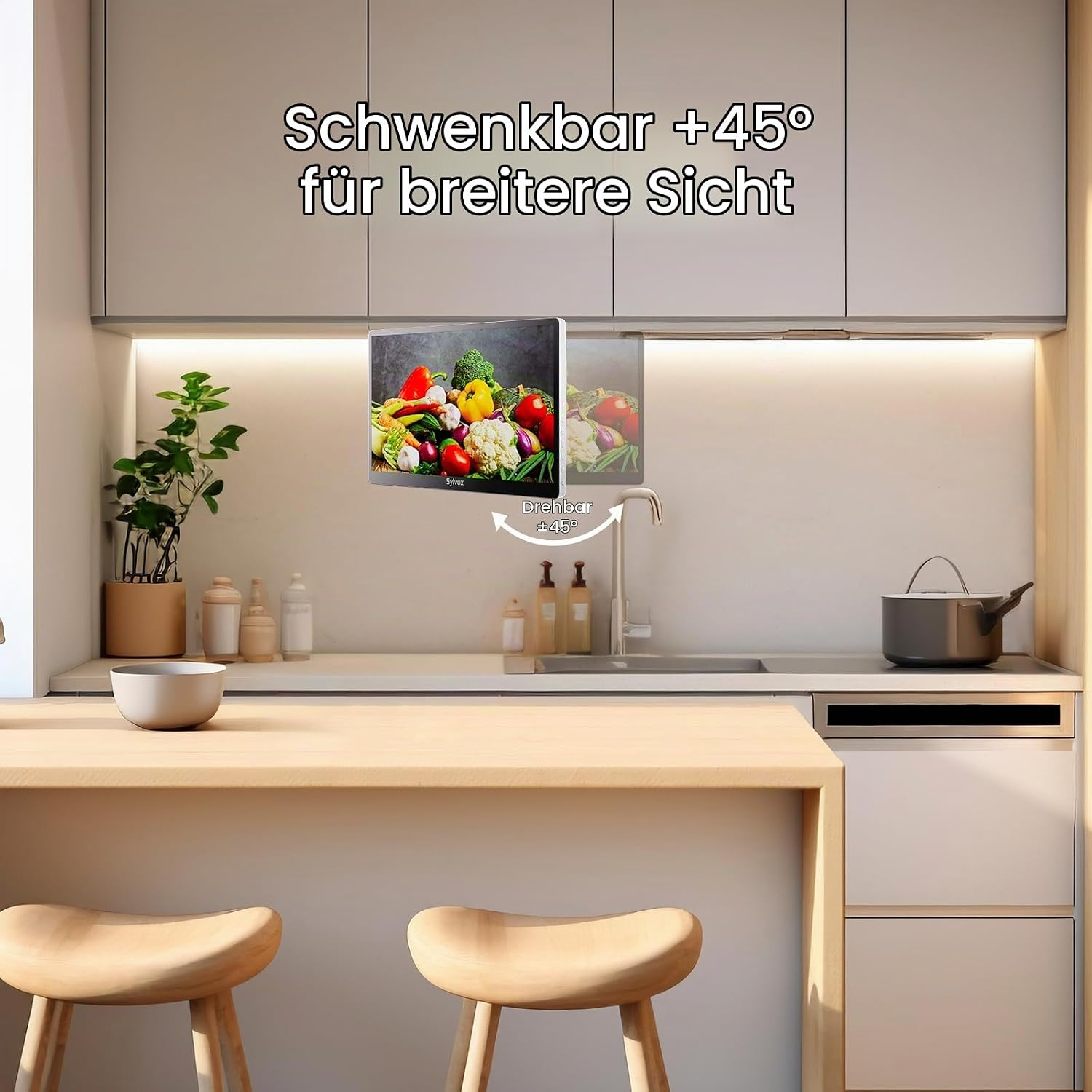 Cocina con un monitor giratorio montado bajo los armarios y texto superpuesto.