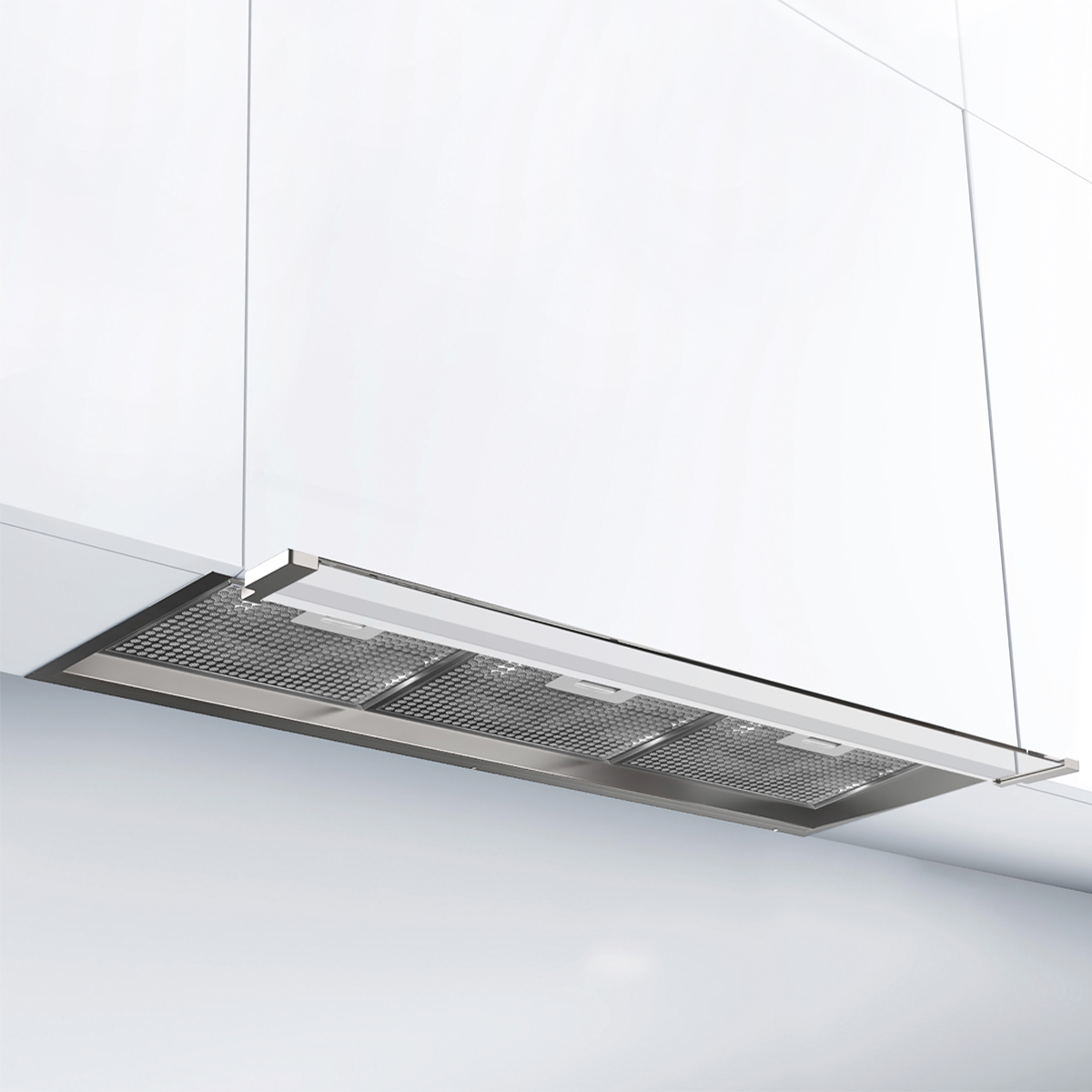 Una campana extractora de acero inoxidable está integrada en un mueble de cocina blanco.
