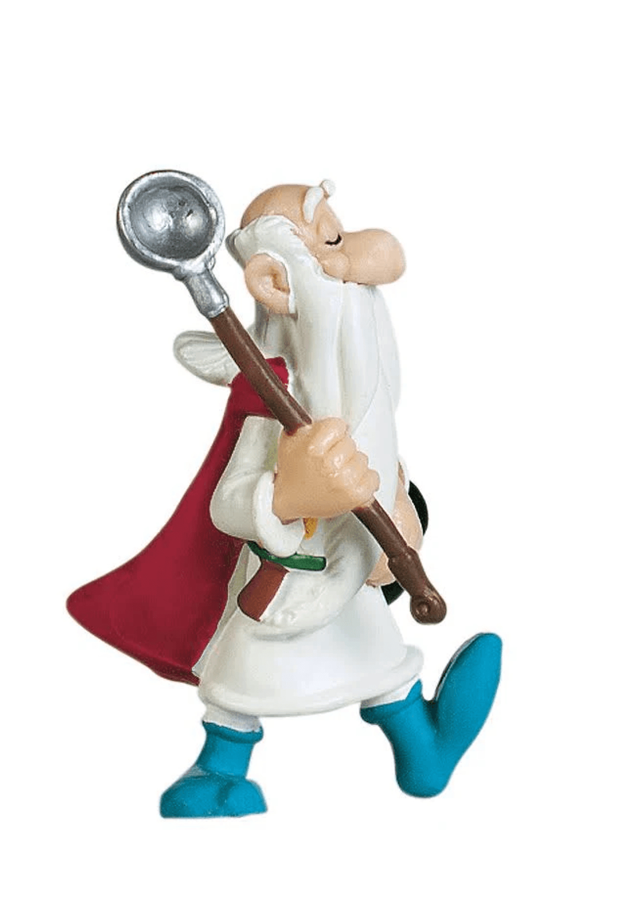Una estatuilla con barba blanca, capa roja, túnica blanca y zapatos azules sostiene un bastón con un cucharón.