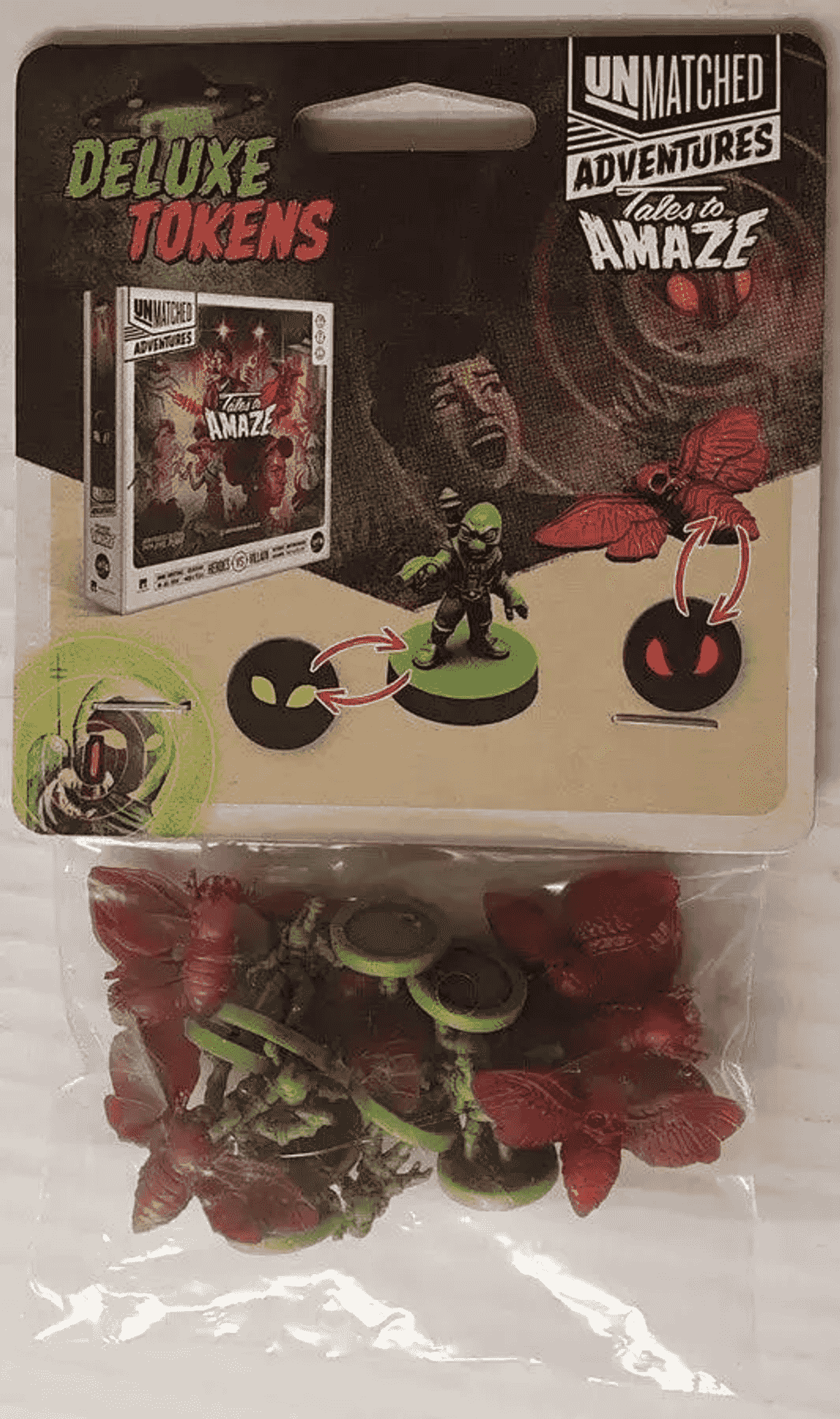 Fichas de lujo empaquetadas para el juego de aventuras Unmatched con figuras rojas y verdes.