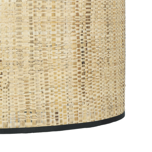 Primer plano de la textura de una pantalla de lámpara de ratán tejido beige cilíndrica con un borde negro.