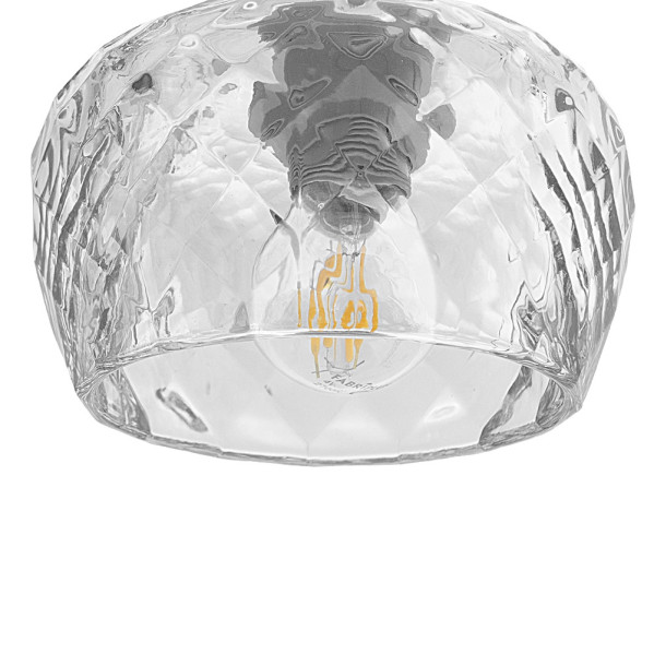Pantalla de lámpara de vidrio transparente facetado con una bombilla de filamento visible dentro sobre fondo blanco.