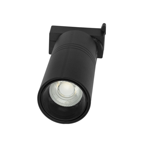 Un foco LED cilíndrico negro con un reflector texturizado sobre un fondo blanco.