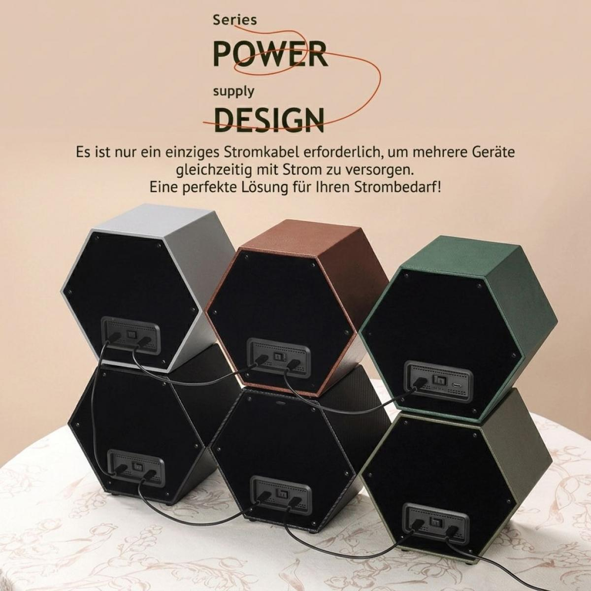 Sechs sechseckige, stapelbare Power-Supply-Module in verschiedenen Farben sind auf einem Tisch miteinander verkabelt.