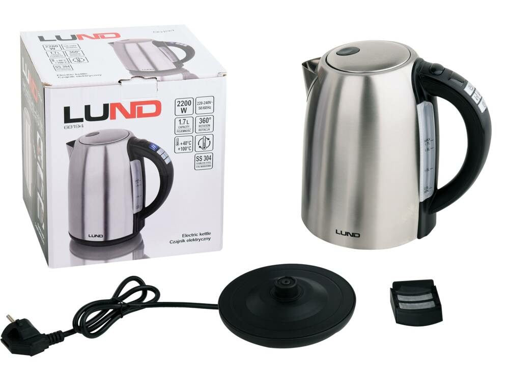 Un bollitore elettrico argentato con la sua base, il cavo di alimentazione e la scatola originale su sfondo bianco.