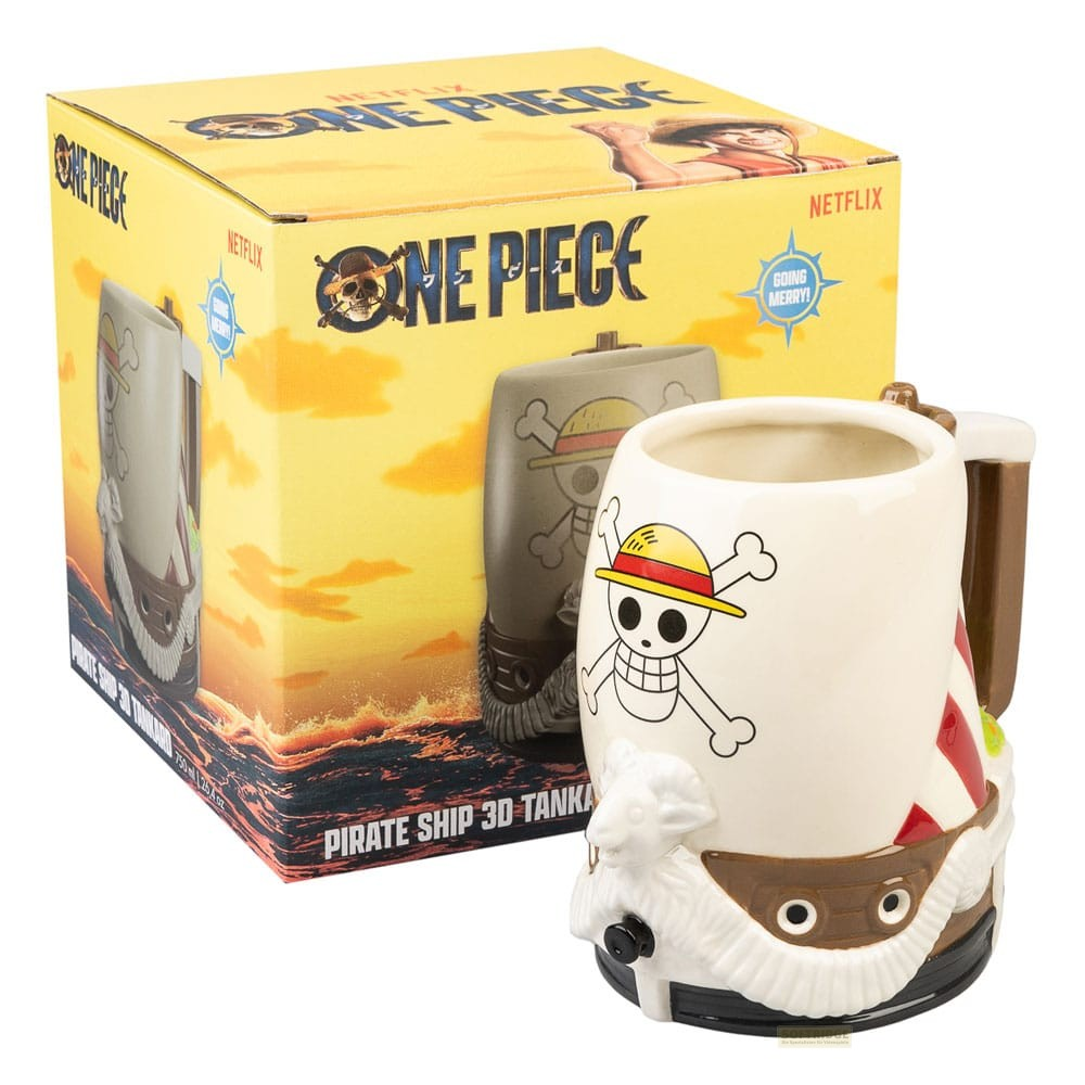 Una taza de barco pirata 3D de One Piece junto a su caja de embalaje amarilla.