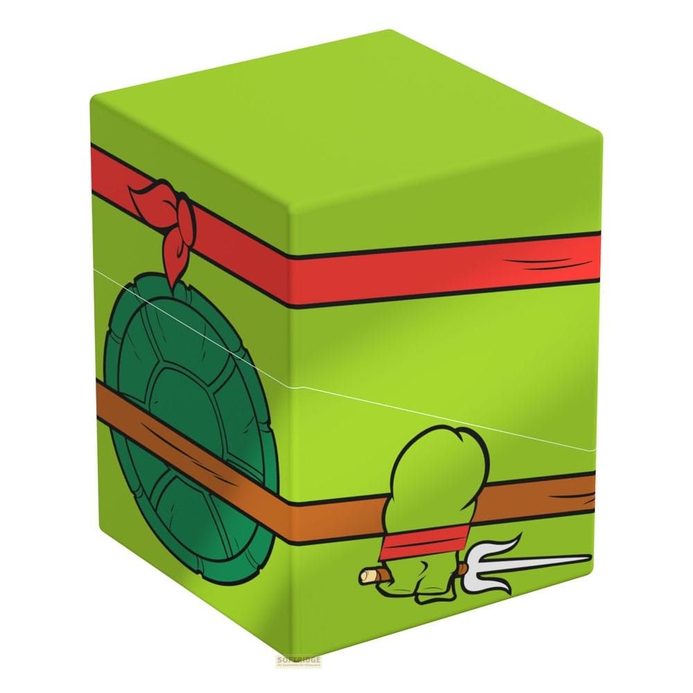 Boîte verte avec ruban rouge, carapace de tortue et arme de style cartoon.
