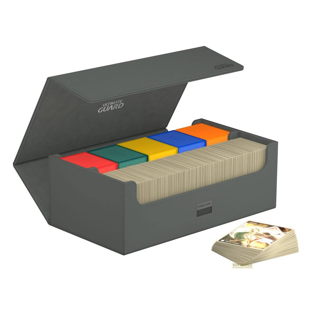 Une boîte de rangement grise ouverte avec des petites boîtes colorées et des piles de cartes à l'intérieur.