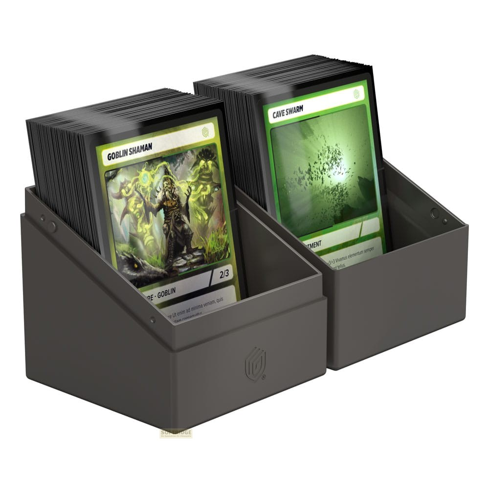 Deux boîtes de deck grises contiennent des cartes à collectionner empilées.