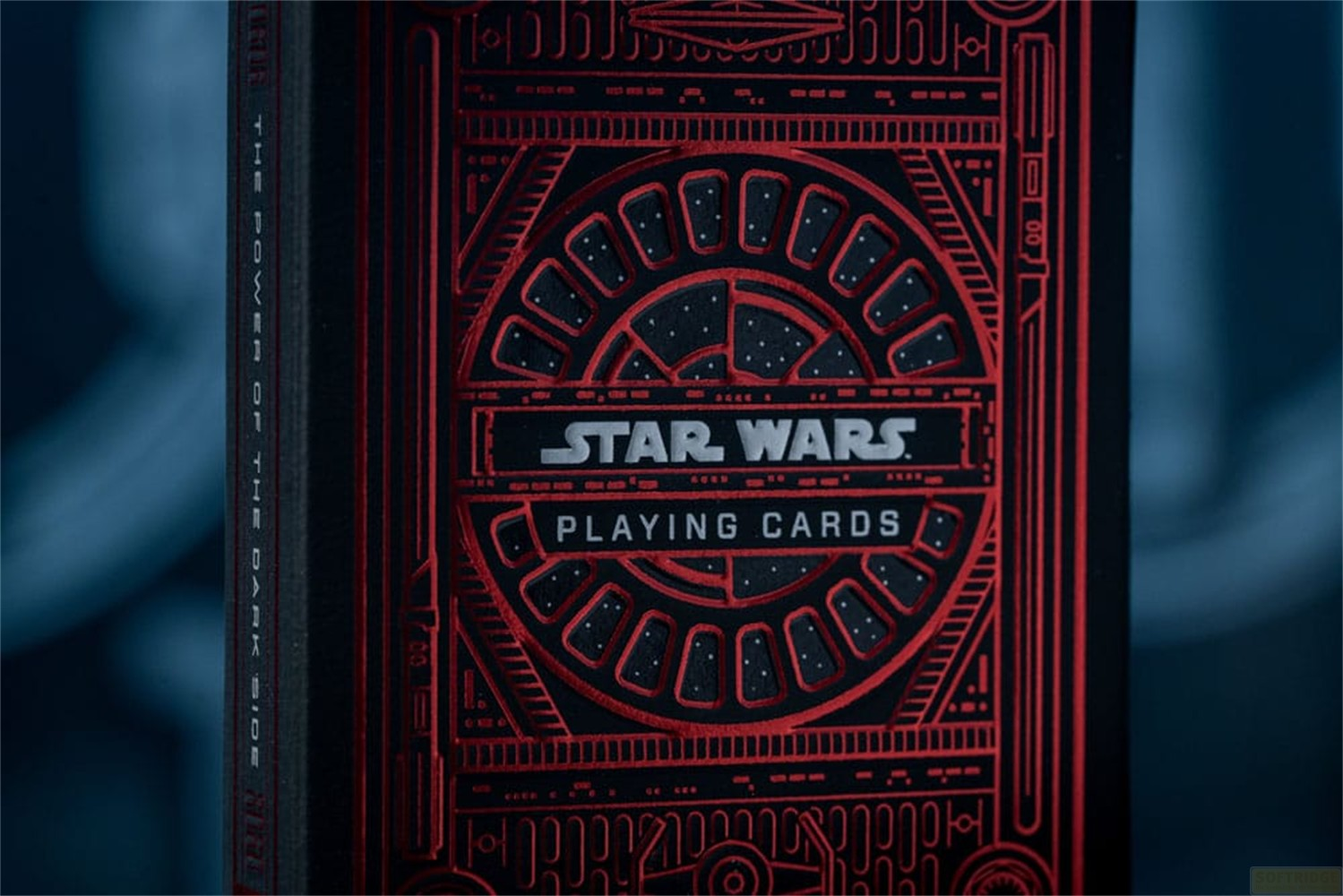Une boîte de cartes à jouer Star Wars noire et rouge présente des motifs métalliques complexes et le logo.