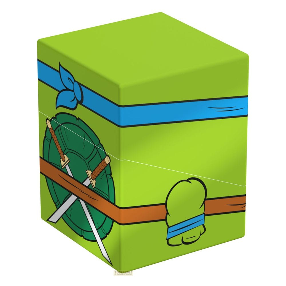 Grüne Box mit blauer Maske, braunem Gürtel und Schild mit gekreuzten Schwertern im Stil einer Ninja-Schildkröte.