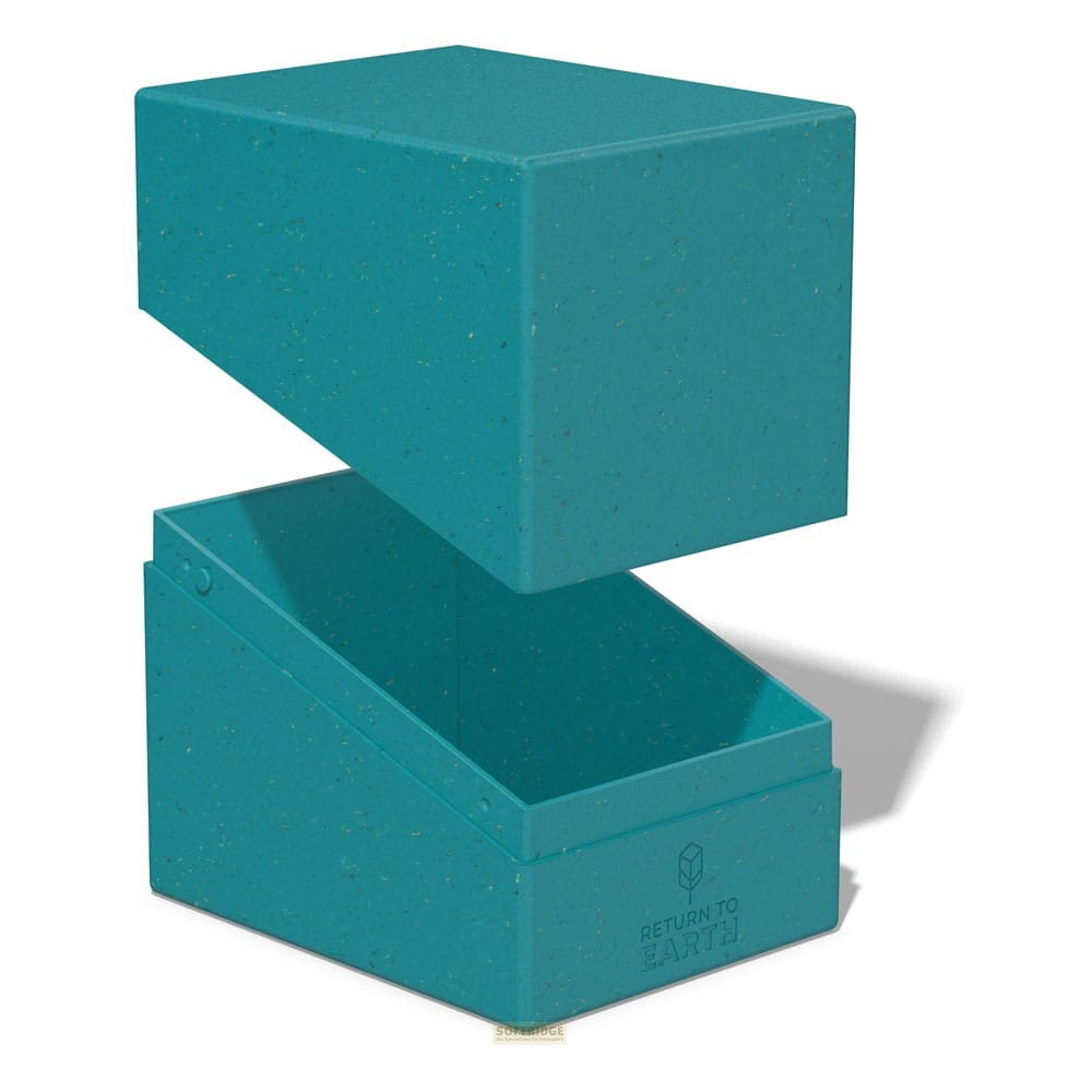 Une boîte ouverte turquoise avec le texte RETURN TO EARTH sur une surface blanche.