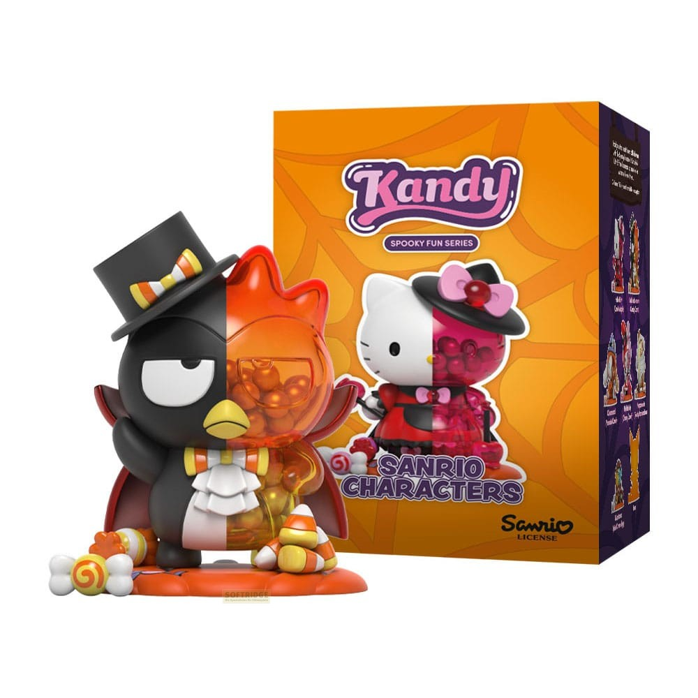 Una figura de pingüino con chistera y capa, mitad naranja transparente llena de caramelos redondos, y su caja.
