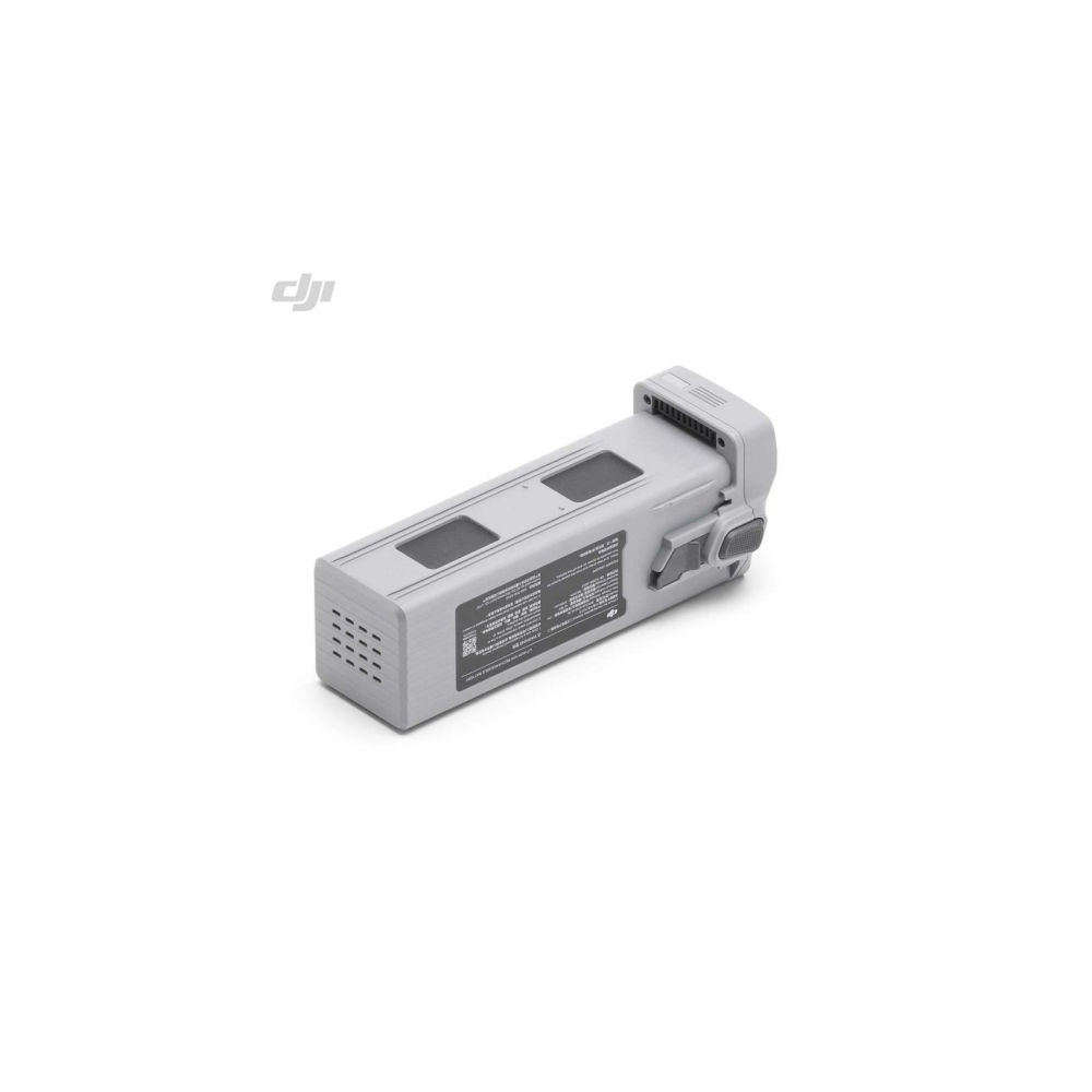 Una batteria per drone DJI grigia con etichette di avvertimento e feritoie di ventilazione su sfondo bianco.