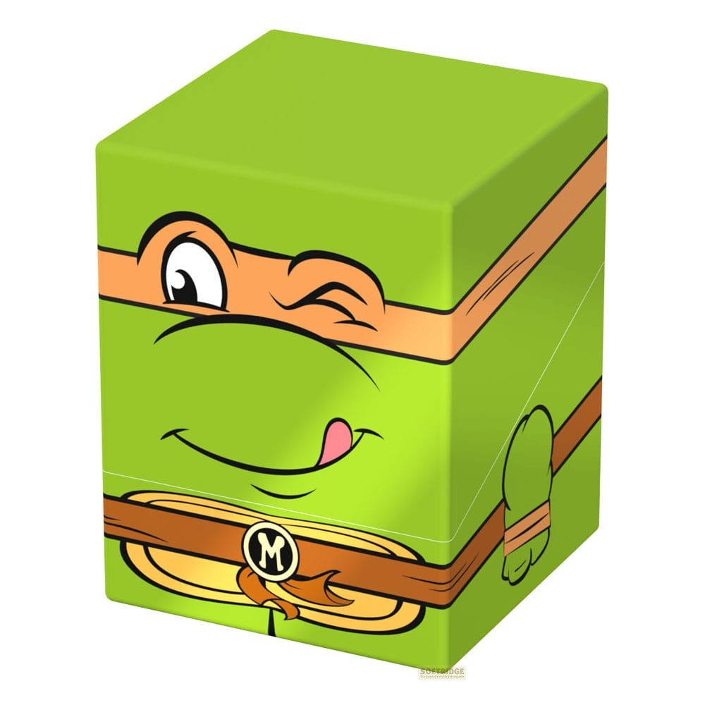 Une boîte de rangement verte avec le visage de Michelangelo des Tortues Ninja, un masque et une ceinture orange.