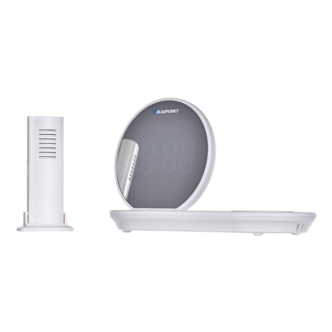 Orologio digitale rotondo Blaupunkt bianco con base e modulo sensore bianco separato su sfondo bianco.