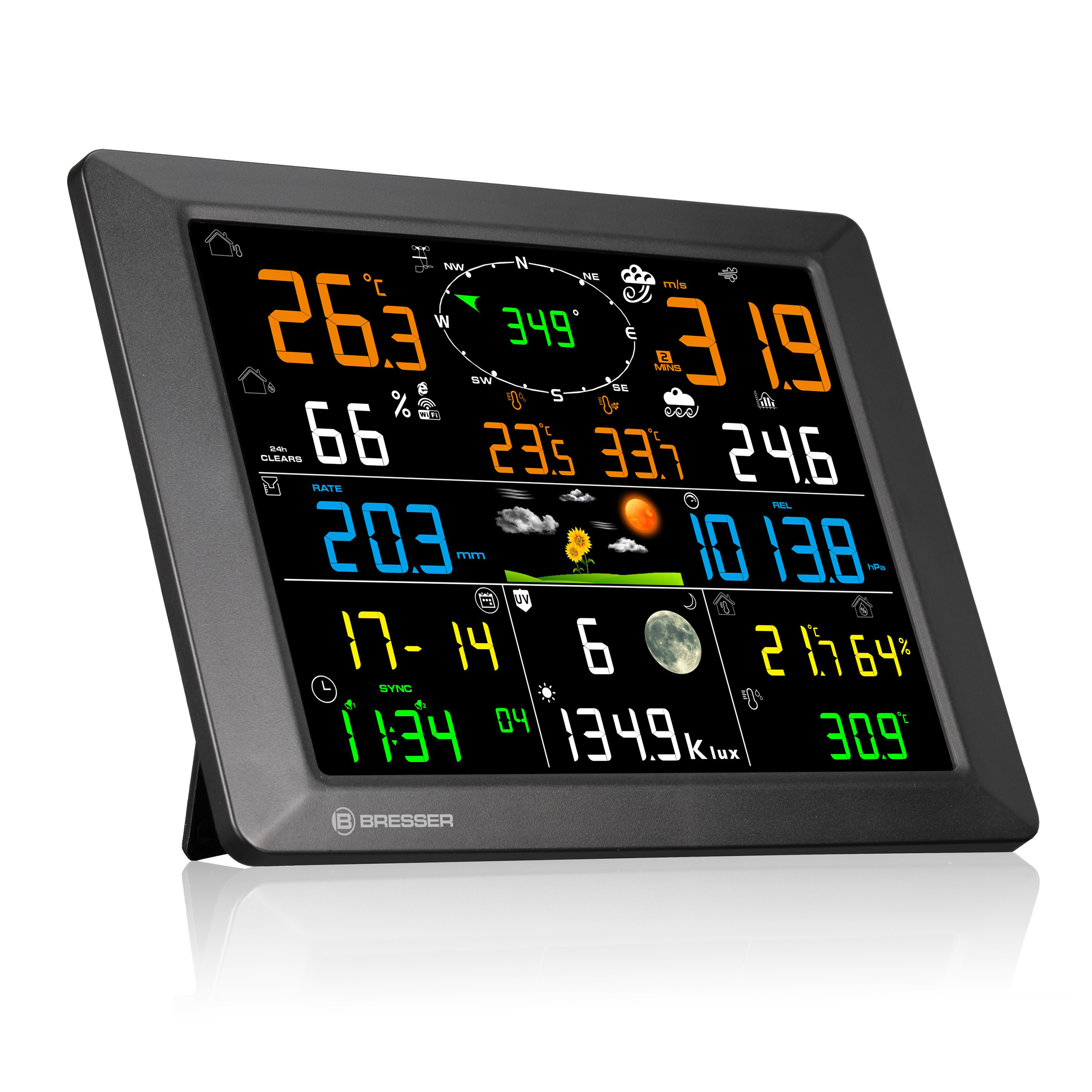 Estación meteorológica digital con marco negro y pantalla LCD colorida que muestra temperatura, viento y hora.