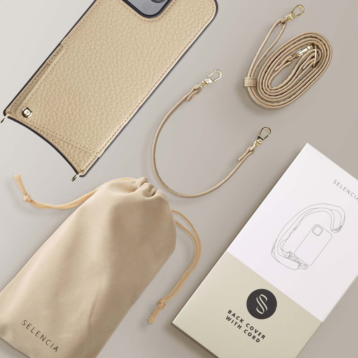 Funda de teléfono beige con correa para el hombro, cordón, bolsa y caja.